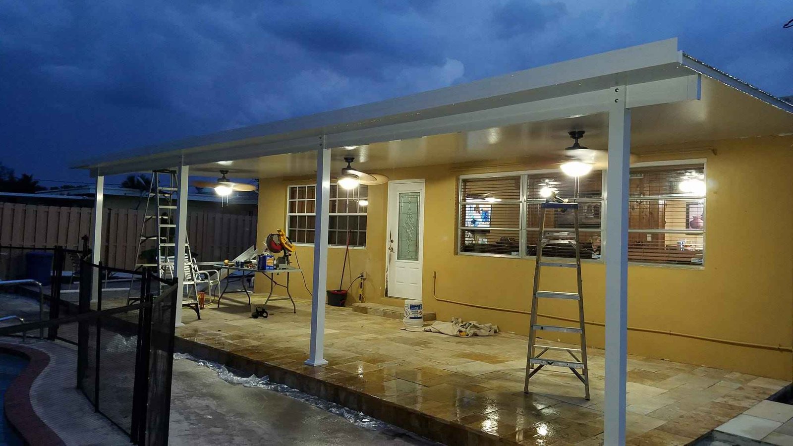 Completed covered patio renovation at dusk